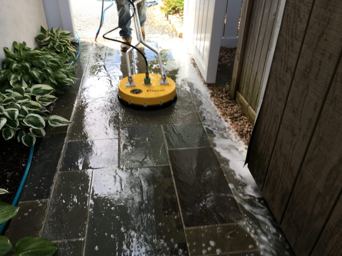 Cleaning slate tiled entry way with pressure washing equipment