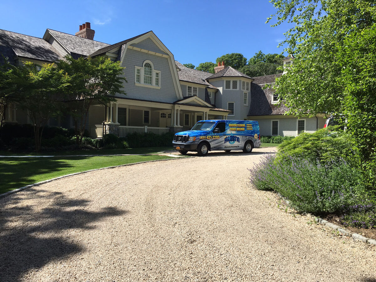 Service van for Majestic Windows & Exterior Cleaning in driveway of Long Island home