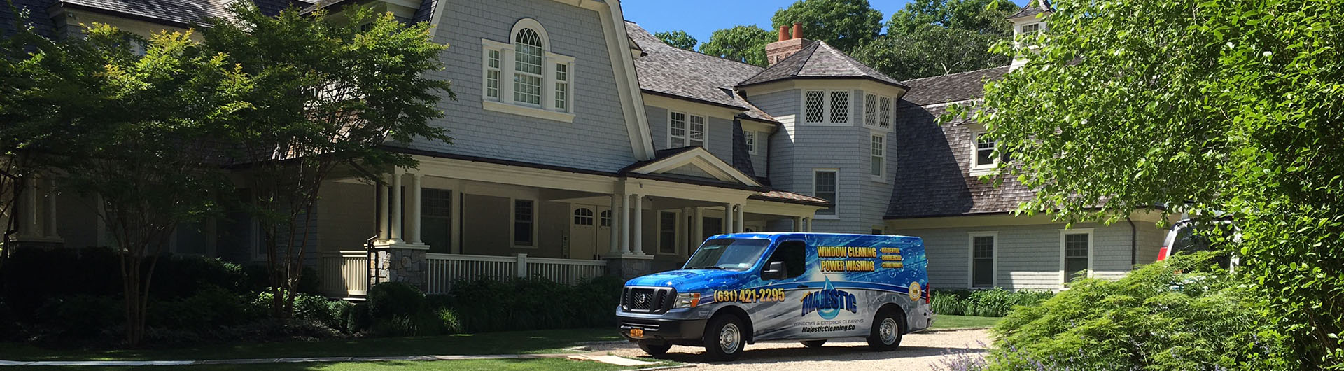 Majestic Window Cleaning and Pressure Washing service van parked outside Long Island home