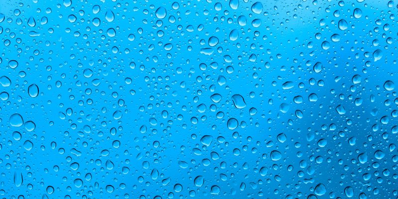 Water droplets scattered across transparent window pane