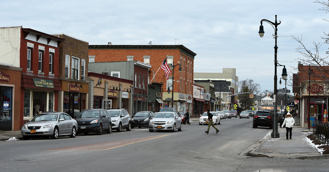 Businesses, cars and pedestrians on Main Street in downtown Westbury, New York