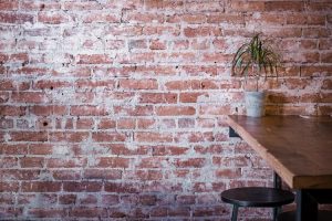 Red brick wall with efflorescence inside coffeeshop