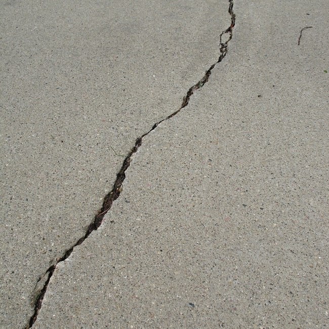 Concrete sidewalk with large diagonal crack