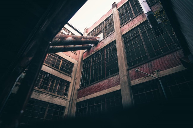 Multi-story building with rusted concrete and large windows